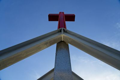 Low angle view of communications tower against blue sky