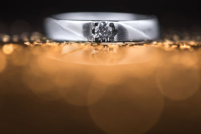 Close-up of wedding rings on table against black background