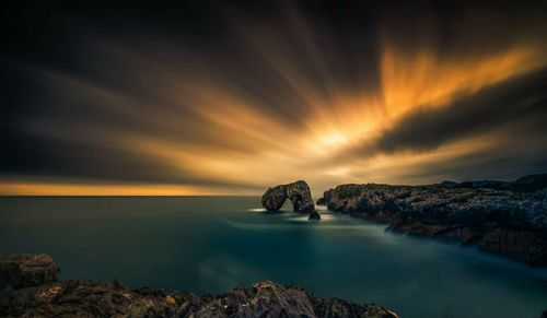 Scenic view of sea against sky at night