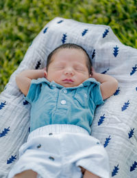 High angle view of cute baby lying on bed