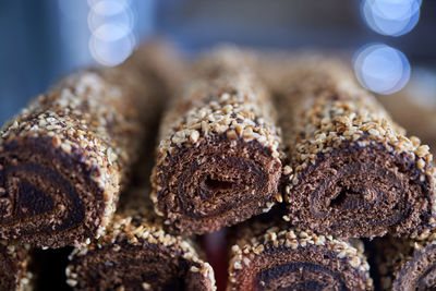 Chocolate sponge cake rolls with cream and crispy almonds