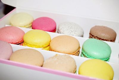High angle view of colorful macaroons arranged in container