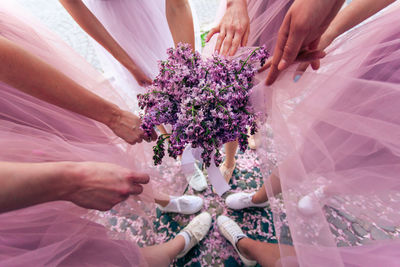 Midsection of woman holding flower bouquet