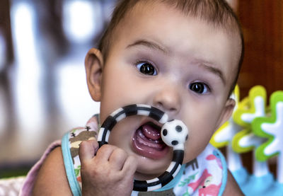 Close-up portrait of cute boy holding camera