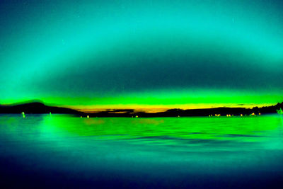 Scenic view of lake against sky at night