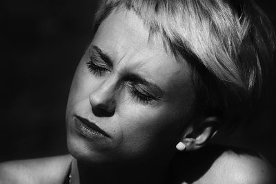 Close-up portrait of a young woman with eyes closed