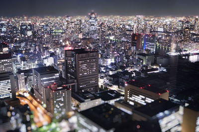 High angle view of illuminated city buildings at night