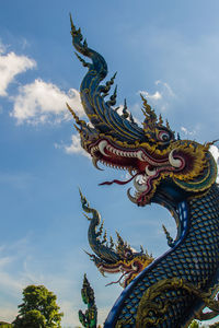 Low angle view of angel statue against sky