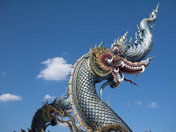 Low angle view of statue against blue sky