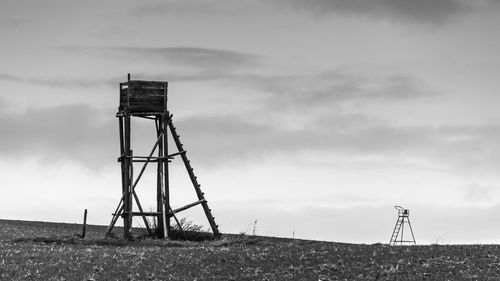 Crane on field against sky