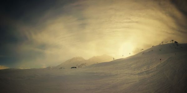 Scenic view of snowcapped mountains against sky during sunset