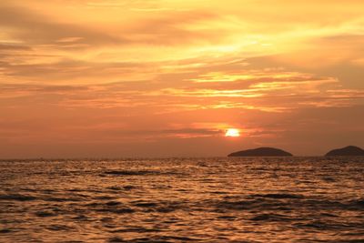 Scenic view of sea against romantic sky at sunset