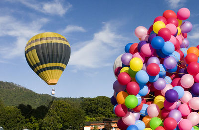 Multi colored hot air balloons flying against sky