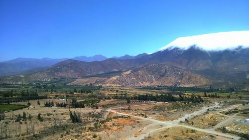 Scenic view of mountains against clear blue sky