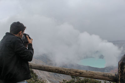 Rear view of man photographing