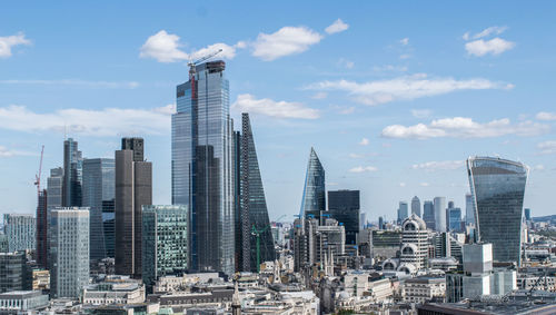 Modern buildings in city against sky