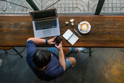 High angle view of man using mobile phone