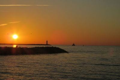 Scenic view of sea against orange sky