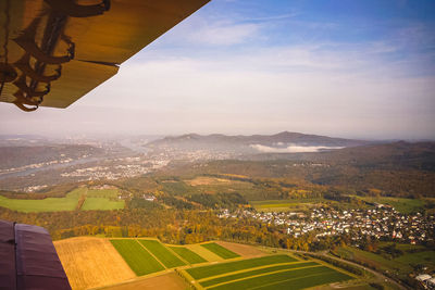 Aerial view of landscape and buildings against sky