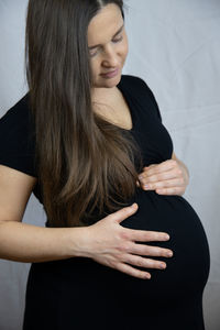 Pregnant woman touching belly