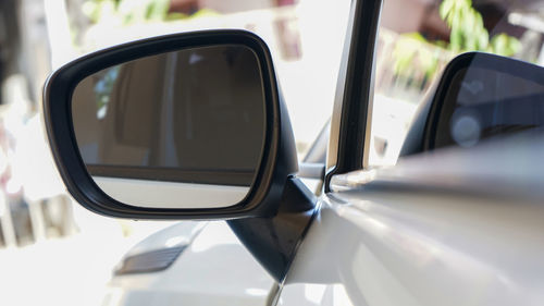 Close-up of side-view mirror of car