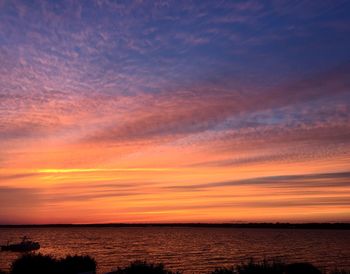 Scenic view of sea against orange sky