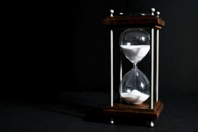 Close-up of clock on table at home