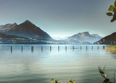 Scenic view of lake and mountains against clear sky