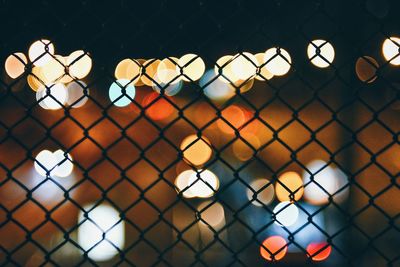 View of illuminated chainlink fence