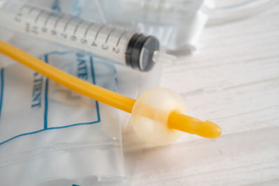 Close-up of syringe on table