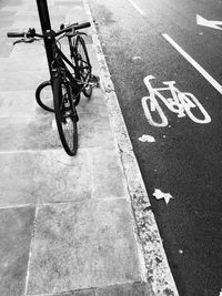 High angle view of bicycle on sidewalk by road