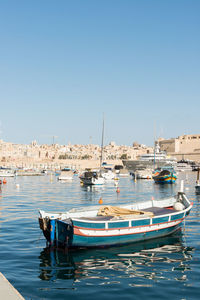 Boats moored at harbor