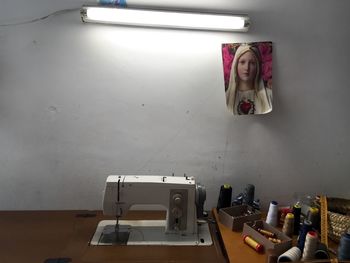 Portrait of woman photographing on table at home