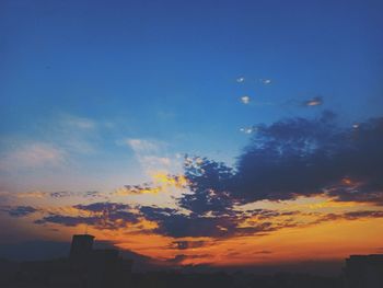 Silhouette buildings against sky during sunset