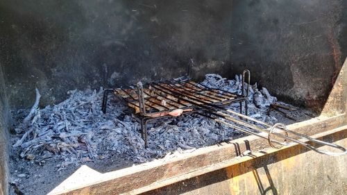 High angle view of logs on barbecue grill