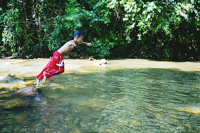 Full length of shirtless man in water
