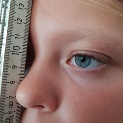 Cropped eye of girl with ruler