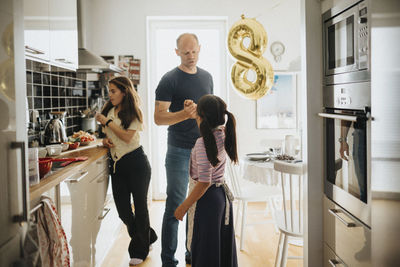 Father and daughters getting ready for birthday party