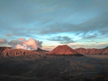 Smoke emitting from volcanic mountain against sky