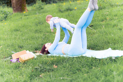 Low section of women relaxing on field