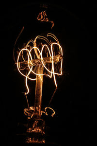 Low angle view of illuminated fire crackers at night