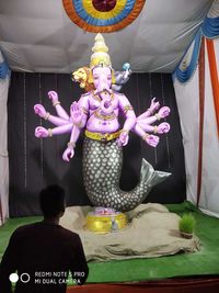 Rear view of buddha statue against temple