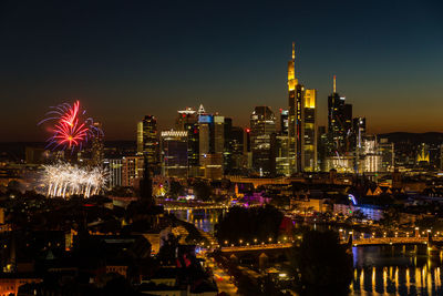 Fireworks mainfest frankfurt in front of illuminated city skyline