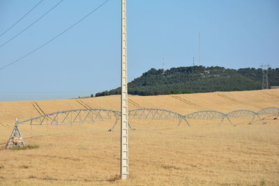 Scenic view of field against clear blue sky