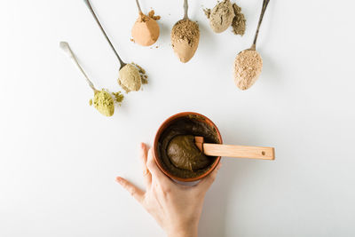 High angle view of wooden clothespins against white background