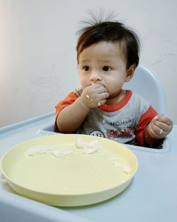 Portrait of cute baby girl on table
