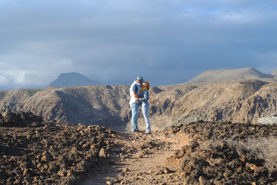 Rear view of man walking on mountain