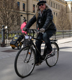 Man riding bicycle on street in city