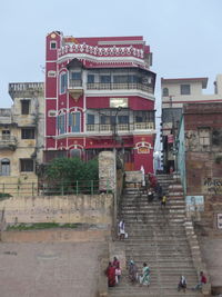 Group of people on building against sky