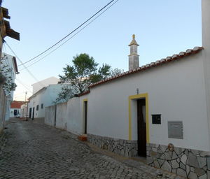 Street amidst buildings against sky